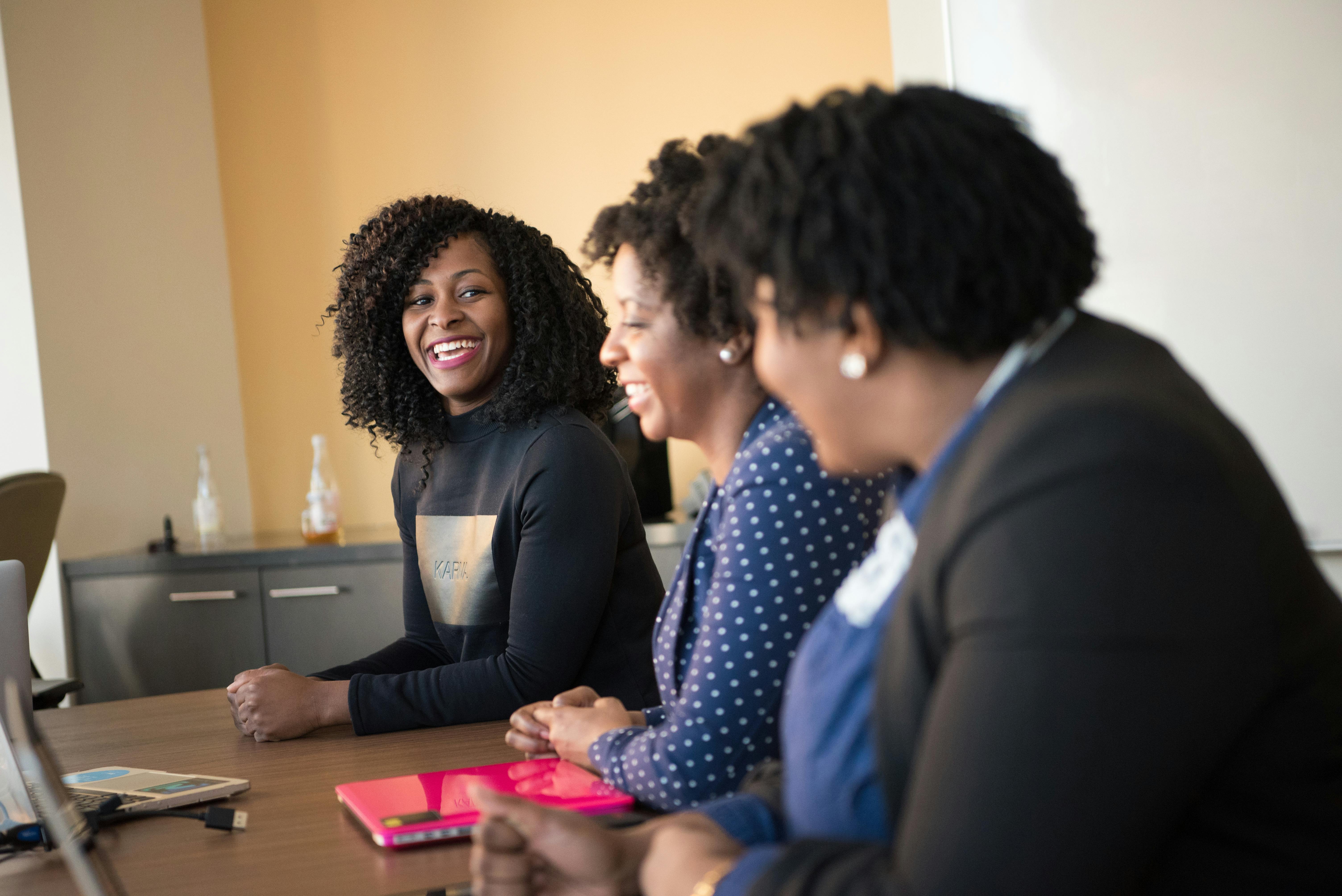 Women collaborating around a table with laptops